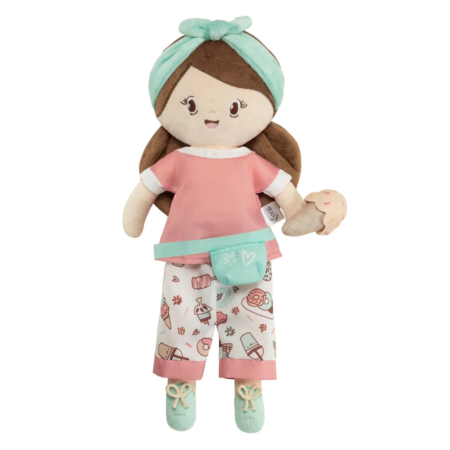 A brown-haired doll with a sweet expression, wearing a pink outfit with patterns, holding a small, round, blue accessory, standing in a kneeling position with its hands extended upwards.