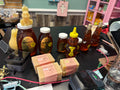 Assorted honey products including bottles and jars on a table.