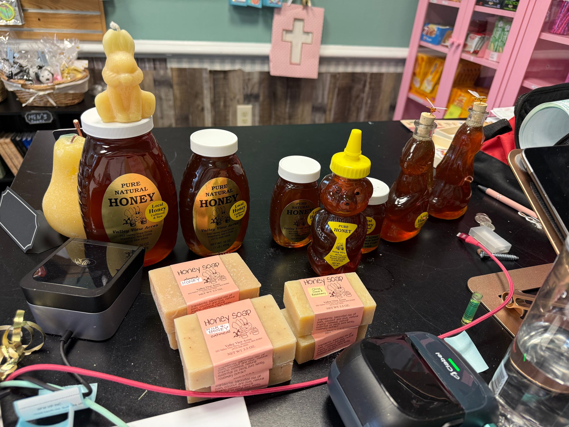 Assorted honey products including bottles and jars on a table.