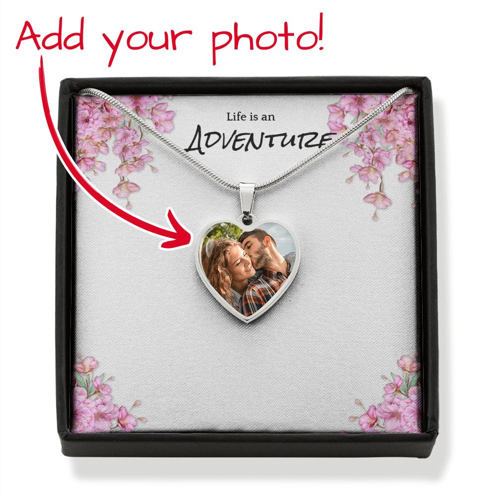 Heart-shaped photo necklace in a decorative box with cherry blossoms.
